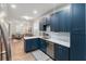 Modern kitchen with white quartz countertops and dark blue cabinetry at 7022 Prosperity Cir # 801, Sarasota, FL 34238