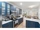 Modern kitchen with blue cabinets, stainless steel appliances, and a breakfast bar at 7022 Prosperity Cir # 801, Sarasota, FL 34238
