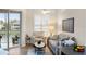 Bright living room with water views, comfy seating, and wood-look floors at 7022 Prosperity Cir # 801, Sarasota, FL 34238