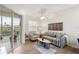 Bright living room with water views, comfy seating, and wood-look floors at 7022 Prosperity Cir # 801, Sarasota, FL 34238