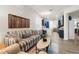 Open living room with a striped sofa and view into the kitchen at 7022 Prosperity Cir # 801, Sarasota, FL 34238