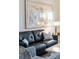 Elegant living room showcasing a black leather sofa and large abstract art piece at 7022 Prosperity Cir # 801, Sarasota, FL 34238