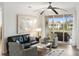 Bright living room with hardwood floors, comfy seating, and sliding glass doors leading to a balcony at 7022 Prosperity Cir # 801, Sarasota, FL 34238