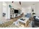 Open living area with built-in shelving, comfortable seating, and a view into the dining area at 7022 Prosperity Cir # 801, Sarasota, FL 34238