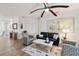 Relaxing living room featuring a ceiling fan and stylish seating arrangement at 7022 Prosperity Cir # 801, Sarasota, FL 34238