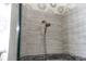 Walk-in shower with gray tile and built-in shower head at 7022 Prosperity Cir # 801, Sarasota, FL 34238