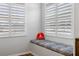 Built-in window seat with a comfortable cushion and a peace sign pillow at 7022 Prosperity Cir # 801, Sarasota, FL 34238