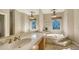 Elegant bathroom with double vanity, soaking tub, and large windows at 7419 Albert Tillinghast Dr, Sarasota, FL 34240