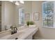 Bright bathroom with double sinks and large windows at 7419 Albert Tillinghast Dr, Sarasota, FL 34240