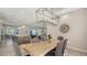 Dining room with live edge table and modern chandelier at 7419 Albert Tillinghast Dr, Sarasota, FL 34240