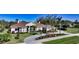 Single-story home with tile roof, palm trees, and landscaped yard at 7419 Albert Tillinghast Dr, Sarasota, FL 34240