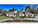 Single-story home with tile roof, landscaping, and circular driveway at 7419 Albert Tillinghast Dr, Sarasota, FL 34240