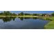Scenic golf course with a tranquil lake reflecting homes at 7419 Albert Tillinghast Dr, Sarasota, FL 34240