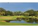 Picturesque golf course with a serene pond and lush landscape at 7419 Albert Tillinghast Dr, Sarasota, FL 34240