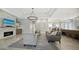 Bright living room features a stone fireplace and hardwood floors at 7419 Albert Tillinghast Dr, Sarasota, FL 34240