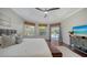Main bedroom with hardwood floors, private door to the pool, and large windows at 7419 Albert Tillinghast Dr, Sarasota, FL 34240