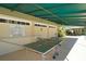 Outdoor ping pong table under covered patio at 7419 Albert Tillinghast Dr, Sarasota, FL 34240
