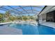 Resort style pool with screened patio, outdoor kitchen and fireplace at 7419 Albert Tillinghast Dr, Sarasota, FL 34240