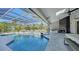 Spacious pool area with covered patio, fireplace and outdoor kitchen at 7419 Albert Tillinghast Dr, Sarasota, FL 34240