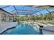 Relaxing pool and spa with screened enclosure and ample lounge space at 7419 Albert Tillinghast Dr, Sarasota, FL 34240