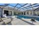 Luxury pool with covered patio, outdoor kitchen and fireplace at 7419 Albert Tillinghast Dr, Sarasota, FL 34240
