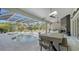 Inviting pool area with covered patio, outdoor kitchen, and fireplace at 7419 Albert Tillinghast Dr, Sarasota, FL 34240