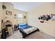 Small bedroom with full-size bed and hat rack at 8120 Enclave Way # 101, Sarasota, FL 34243