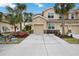 Tan three-story townhome with two-car garage at 8120 Enclave Way # 101, Sarasota, FL 34243