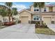 Tan three-story townhome with two-car garage and landscaping at 8120 Enclave Way # 101, Sarasota, FL 34243