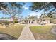 Landscaped backyard with a paver pathway and fire pit at 8135 Longbay Blvd, Sarasota, FL 34243