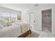 Charming bedroom with white bedding and en-suite bathroom at 8135 Longbay Blvd, Sarasota, FL 34243