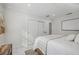 Spacious bedroom with white bedding and private access at 8135 Longbay Blvd, Sarasota, FL 34243