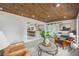 Open Gathering room with wood ceiling and view of kitchen at 8135 Longbay Blvd, Sarasota, FL 34243