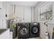 Convenient laundry room with washer, dryer, and utility sink at 8135 Longbay Blvd, Sarasota, FL 34243