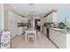 Bright kitchen boasts white cabinets, stainless steel appliances, and an island at 8608 53Rd W Ave, Bradenton, FL 34210