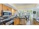 Well-lit kitchen with stainless steel appliances, granite countertops and wooden cabinets at 919 82Nd Nw St, Bradenton, FL 34209