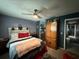 Cozy bedroom with a queen-size bed and wooden armoire at 1007 Longfellow Cir, Sarasota, FL 34243