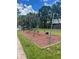 Community playground with swings set on wood chip surface at 1007 Longfellow Cir, Sarasota, FL 34243