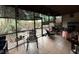 Screened porch with seating area, and backyard access at 1007 Longfellow Cir, Sarasota, FL 34243