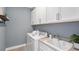 Laundry room with white cabinets and a washer and dryer at 10518 Eclipse St, Sarasota, FL 34241