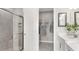 Bathroom with double vanity, walk-in shower, and linen closet at 10522 Eclipse St, Sarasota, FL 34241