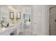 Bathroom with double vanity and a view into the bedroom at 10522 Eclipse St, Sarasota, FL 34241