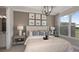 Main bedroom with wood wall and large window overlooking the backyard at 10522 Eclipse St, Sarasota, FL 34241