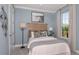 Light blue bedroom with a comfortable bed and natural light at 10522 Eclipse St, Sarasota, FL 34241