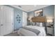 Light blue bedroom with a queen bed and wood headboard at 10522 Eclipse St, Sarasota, FL 34241