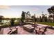 Community fire pit with seating area and lake view at 10522 Eclipse St, Sarasota, FL 34241