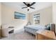 Bright bedroom with a bed, two chairs, and a window overlooking the backyard at 1379 E Price Blvd, North Port, FL 34288