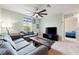 Bonus room with sectional sofa, coffee table and TV; view of bedroom at 1379 E Price Blvd, North Port, FL 34288