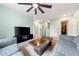 Bonus room with sectional sofa, coffee table, TV, and access to mechanicals at 1379 E Price Blvd, North Port, FL 34288