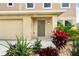 Two-story house with a tan exterior and a gray front door at 1379 E Price Blvd, North Port, FL 34288